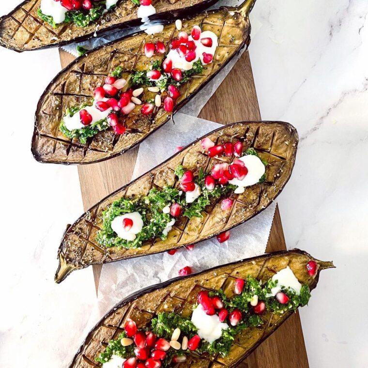 Roasted Eggplants Topped With Lemon Parsley Sauce And Pomegranate Seeds